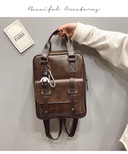 Detail of dark brown vintage faux leather backpack with metallic buckle and bear charm