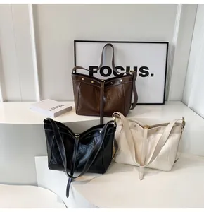 Detailed comparison of brown, black and beige PU tote bags with stylish pleated texture