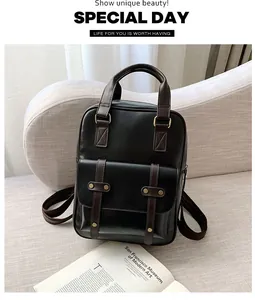 Detail view of the vintage faux leather backpack featuring gold rivet accents and dual handles
