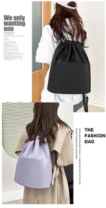 Detail view of water-resistant nylon drawstring backpacks in black and pale lavender colors