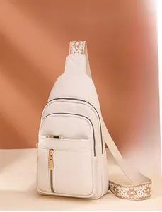 Detail view of cream PU leather chest bag featuring lychee texture and golden zippers