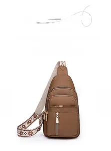 Detail of dark brown water-resistant PU leather chest bag with pebble texture and zippers