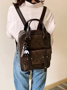 Retro brown PU leather backpack for women featuring a vintage British style with bear charm