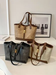 Drei Vintage Canvas-Leder-Einkaufstaschen mit Goldschnallen im minimalistischen Studio