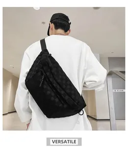 Rear view of model wearing a black checkered crossbody bag with adjustable straps
