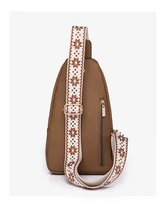 Detail of dark brown lychee leather chest bag featuring bohemian ethnic patterned strap