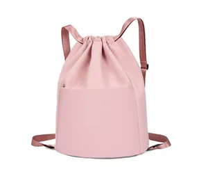 Side view of pink nylon drawstring backpack showing smooth fabric and side zipper detail