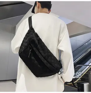 Close-up of black checkered texture chest bag with durable zippers and wide strap