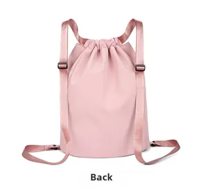 Detailed back view of pink drawstring backpack showing shoulder straps and texture