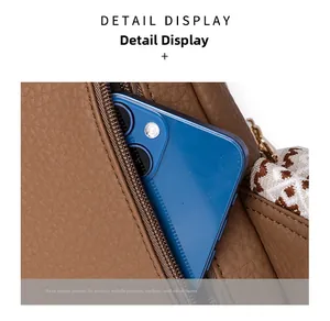 Detail view of the secure back zipper pocket for phones and wallets on the brown PU bag