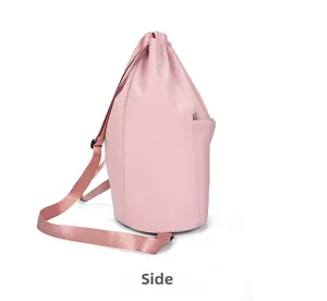 Side view of pink drawstring nylon backpack showing side zipper pocket and adjustable strap