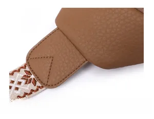 Detail of premium brown lychee texture leather chest bag with precise reinforced stitching