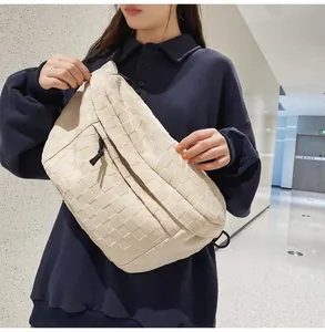 Close-up of the woven checkered pattern and texture on a beige large crossbody bag