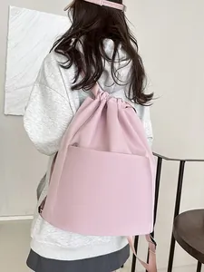 Pink nylon drawstring backpack with front zipper pocket for gym and travel use