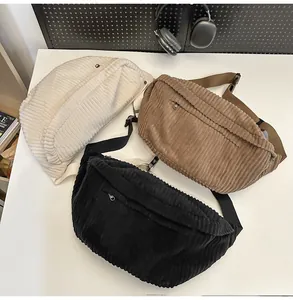 Detailed corduroy texture on white, brown and black crossbody bags with zippers