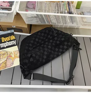 Detail of checkered pattern texture on black crossbody bag with durable plastic buckle