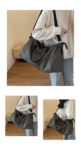 Deep taupe duffel bag details showing waterproof fabric and premium leather handles