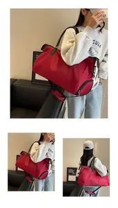 Detail of red travel bag with side zipper pocket and adjustable shoulder strap