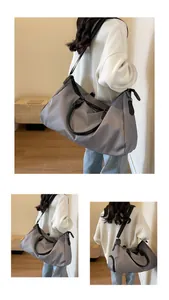 Detail view of large grey nylon travel bag showing crossbody strap and side capacity