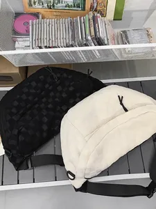 Japanese style checkered crossbody chest bag in black and beige woven fabric