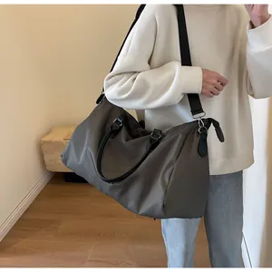Detail of the large travel bag with olive green waterproof fabric and black straps