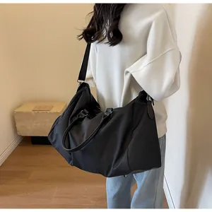 Detail of durable black waterproof nylon travel bag with smooth leather handles