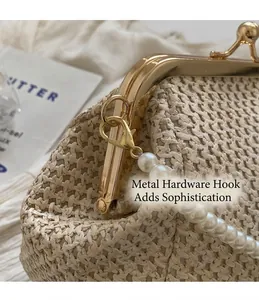 Detailed macro view of the golden metal lobster clasp and elegant pearl chain handle