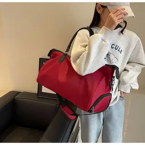 Detail of red large-capacity fitness travel bag with independent side zipper shoe compartment