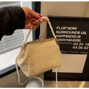 Detailed close-up of beige woven texture and elegant pearl handle on retro shell bag