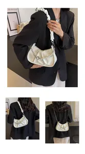 Detail of off-white ruched cloud bag with pearl heart chain and soft pleated texture