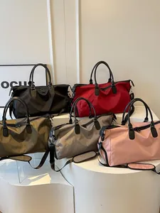 Large capacity waterproof travel bag for women available in five solid colors on display