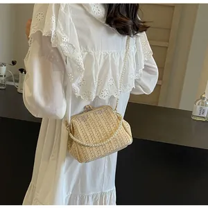 Detailed view of woven shell bag with vertical texture and elegant pearl crossbody strap