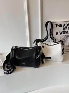 Stylish 2025 minimalist leather crossbody pillow bags in black and white with wide straps