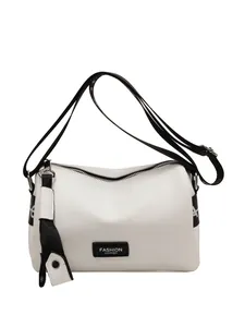 Chic white lychee leather pillow bag with black contrast strap and fashion logo