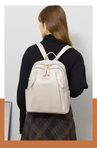 Close-up of beige PU leather backpack texture and side pocket detail on model
