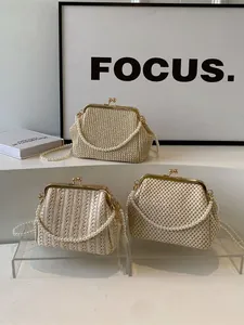 Vintage shell-shaped straw clutch bags with pearl handles and kiss-lock gold metal closures