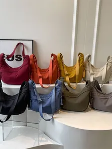 Nylon crescent crossbody bags in eight vibrant colors with adjustable straps for travel