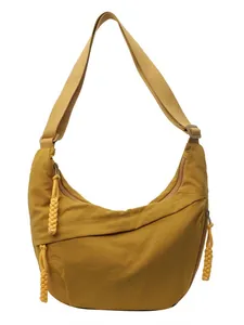 Ginger yellow nylon crescent crossbody bag with adjustable strap and braided zipper pull
