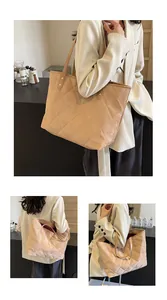 Detail view of beige quilted tote bag with refined velvet texture and rivet straps