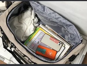 Detailed interior of a beige travel bag showing a large zipper pocket and storage space