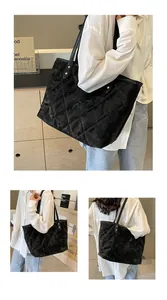 Detail of black quilted velvet tote bag featuring golden studs and elegant stitching texture