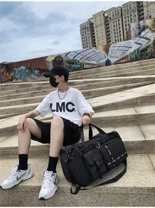 Detailed view of black travel bag with side zipper pockets and durable shoulder straps