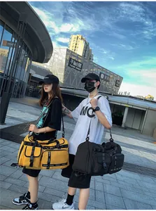 Detailed outdoor view of large waterproof travel bags in yellow and black with straps