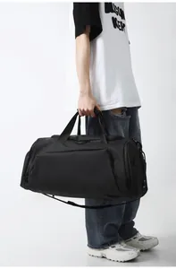 Detail of black large capacity fitness bag with reinforced handles and travel compartments
