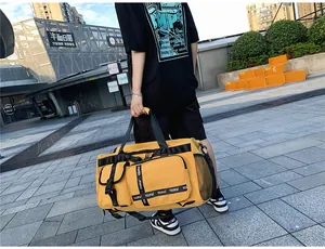 Detailed view of yellow waterproof travel bag with side mesh pocket and buckle