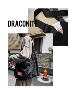 Close-up of the adjustable nylon shoulder strap and durable black canvas on a large tote bag