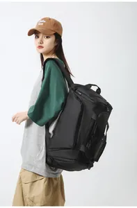 Detail view of large black waterproof sports backpack showing side handle and wide straps