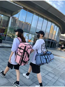 Detailed view of pink and blue travel bags featuring durable straps and multiple side pockets