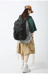 Rear view of a large black waterproof gym backpack with reinforced handles for travel