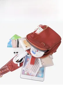 Interior view of brown lychee leather crossbody bag with spacious multi-layer storage